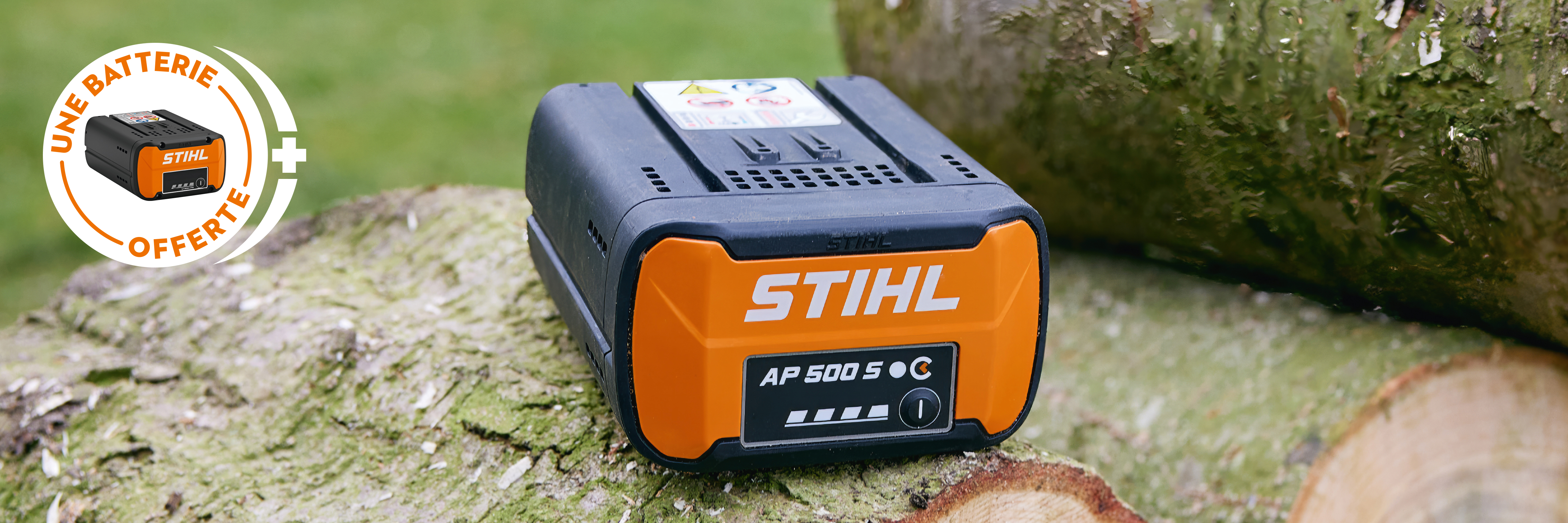 Batterie STIHL AP 500 S dans la benne d’un pick-up avec la nouvelle tronçonneuse à batterie STIHL MSA 300, avec une affiche d’une batterie STIHL portant l’inscription « Get a free battery ».